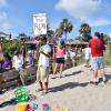 A protester holds up a sign to "Stop the Flow" referring to the flow of algae lacked water from Lake Okeechebee into the St. Lucie River